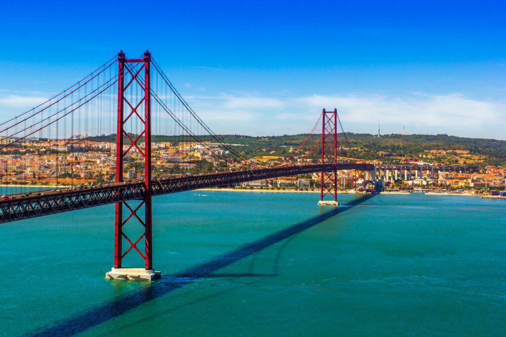 A stunning view of the iconic Ponte 25 de Abril suspension bridge over the Tagus River in Lisbon, Portugal.
